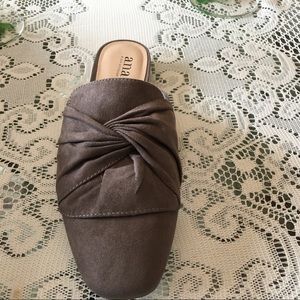 A beautiful pair of taupe faux mules .NEW